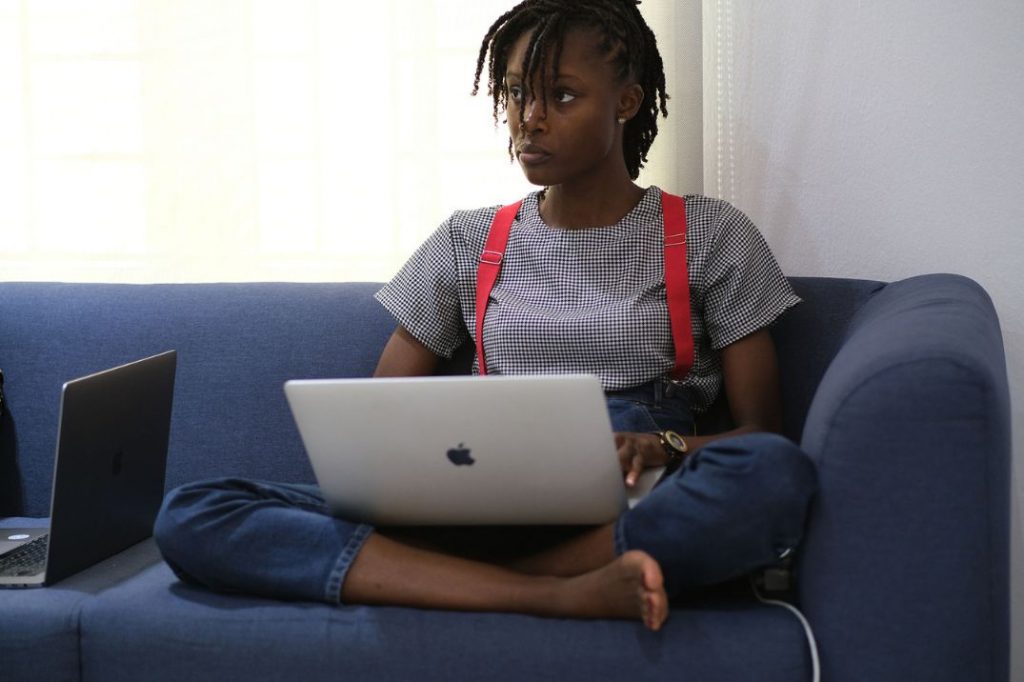 lady sitting on the couch working with laptop