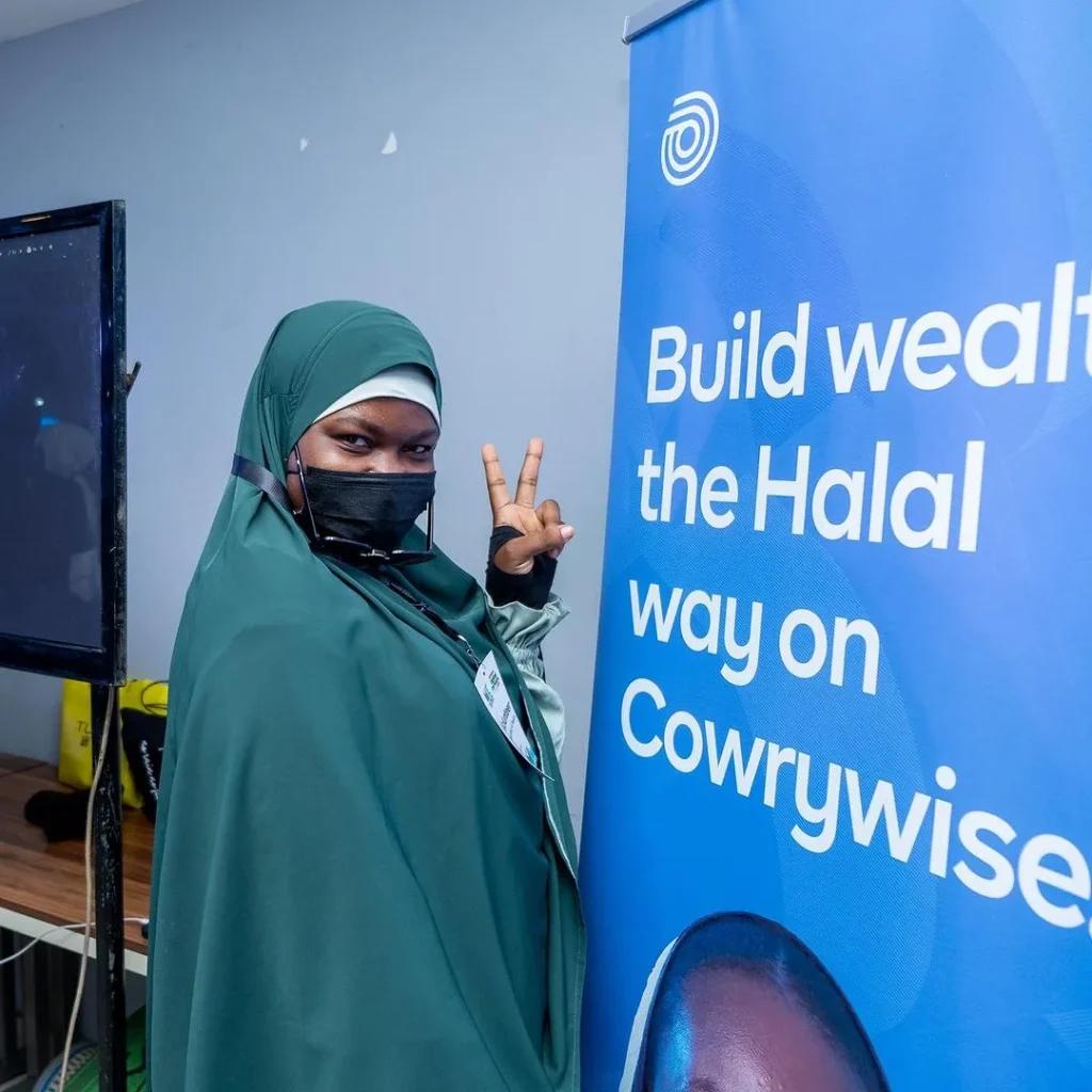 mte attendee posing by cowrywise rollup banner